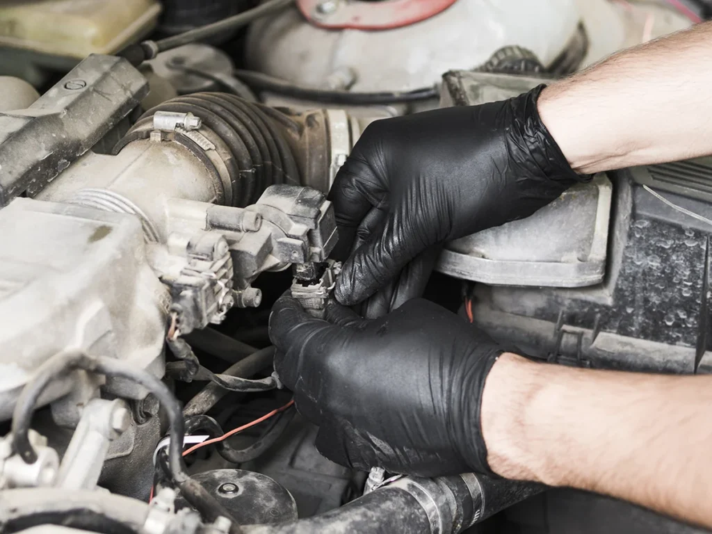 mechanic inspecting fuel system during cummins engine maintenance to check diesel injector connections