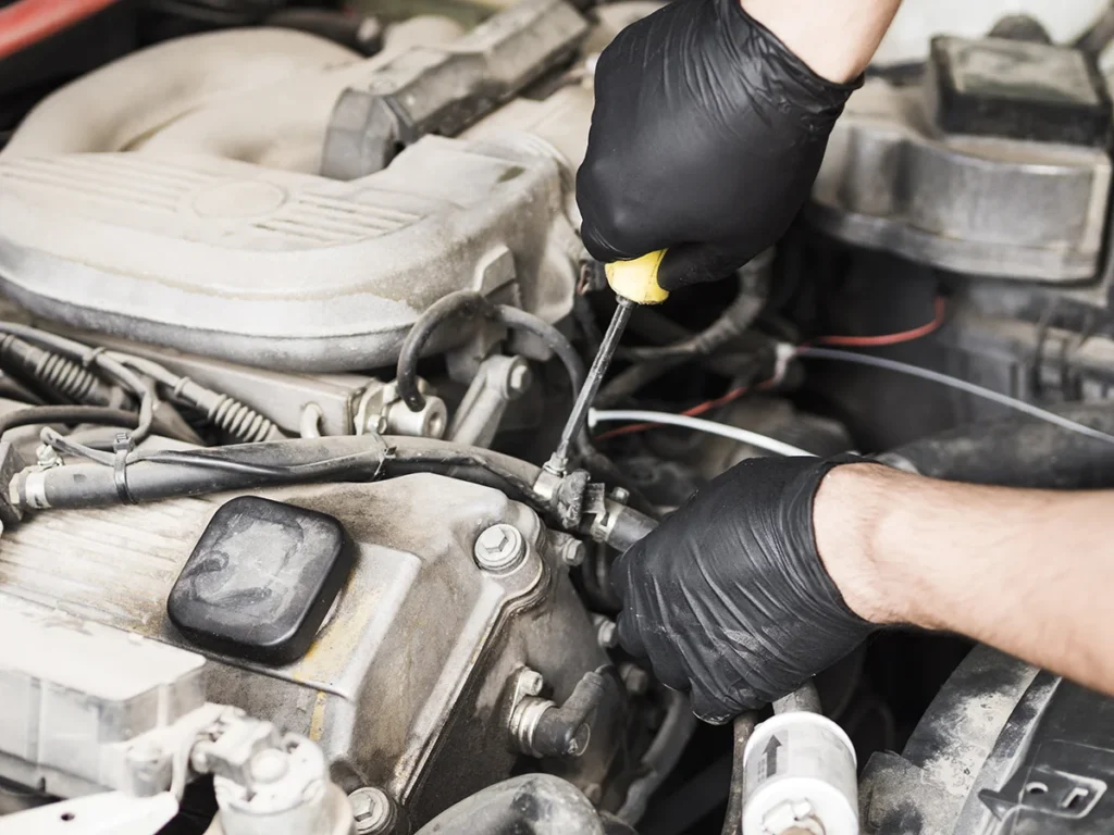 technician inspecting fuel system components during diesel engine troubleshooting procedure