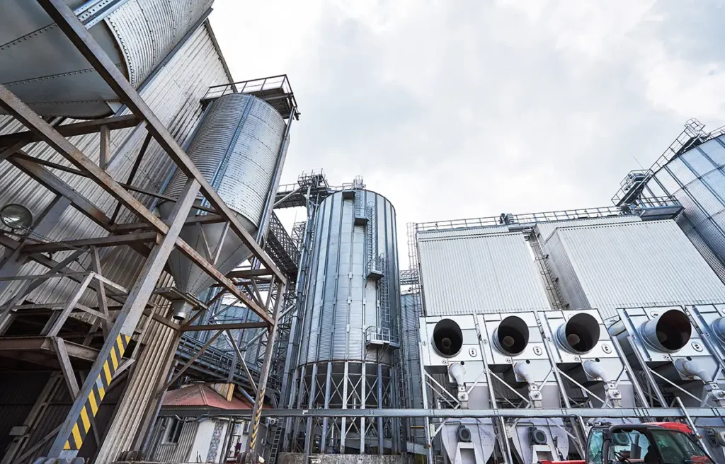 industrial generator engines supporting industrial infrastructure with metal silos and processing equipment