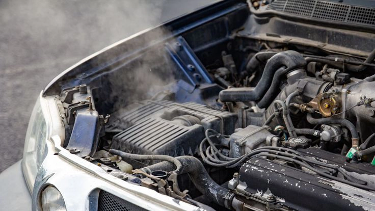 overheating car engine producing steam during diesel engine troubleshooting inspection