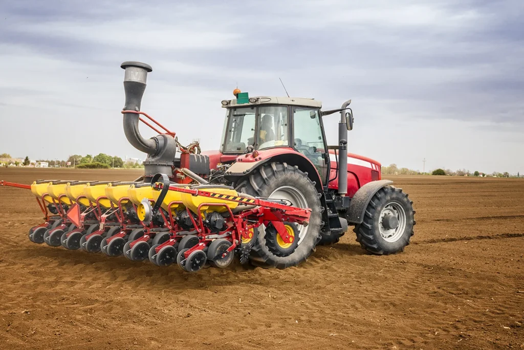 tractor with seeder using engines for agricultural machinery in farming field