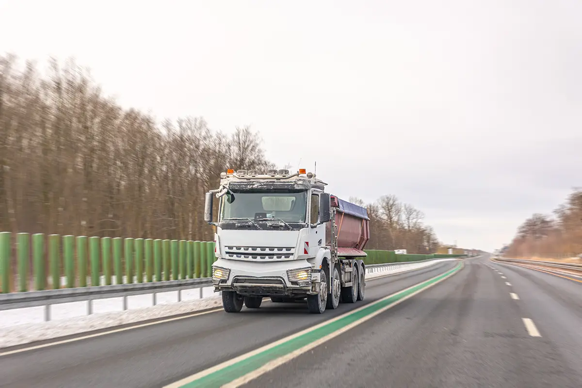 dump truck engine powering truck on highway transport