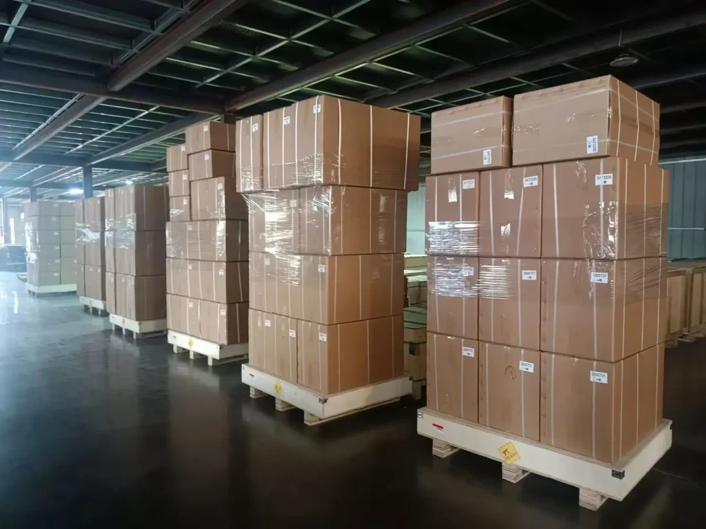 Cummins engine parts loaded in shipping containers, ready for delivery.