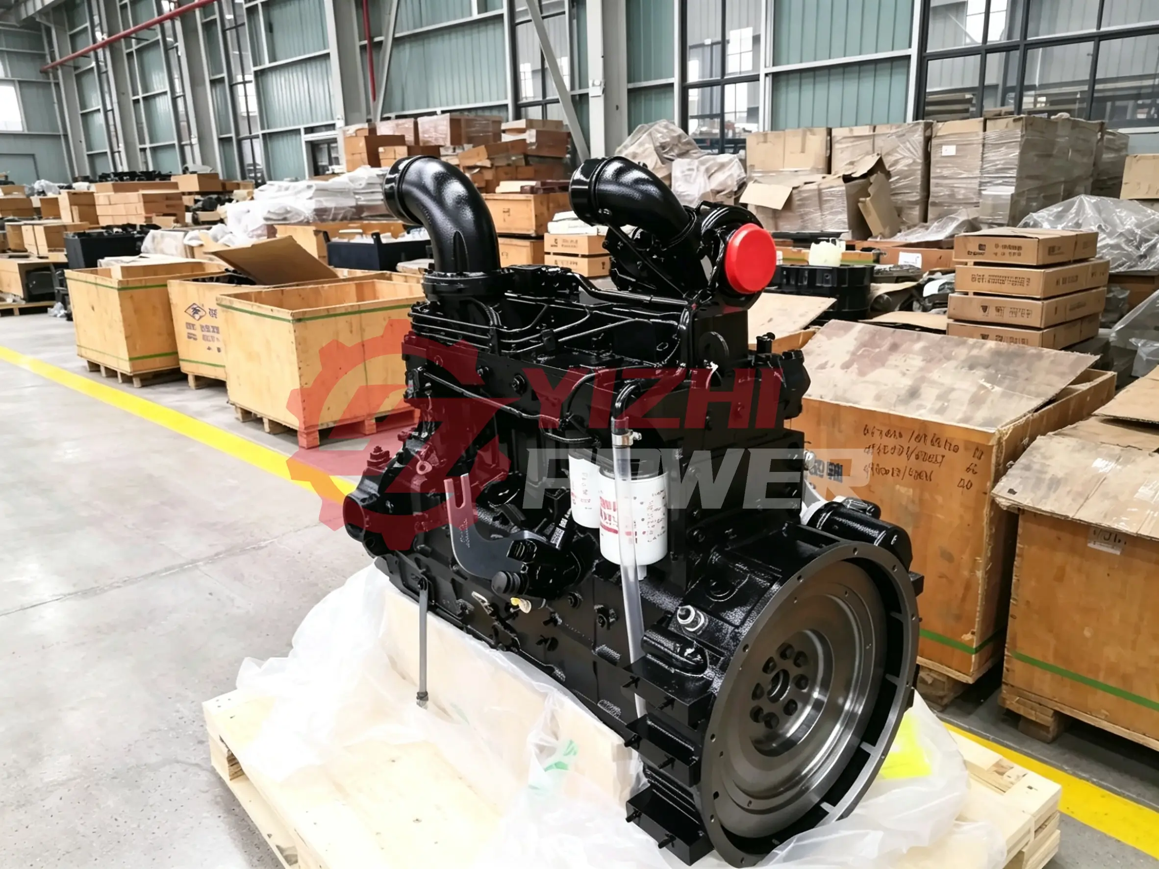 Cummins 6CT engine assembly with flywheel housing on wooden pallet for export packaging
