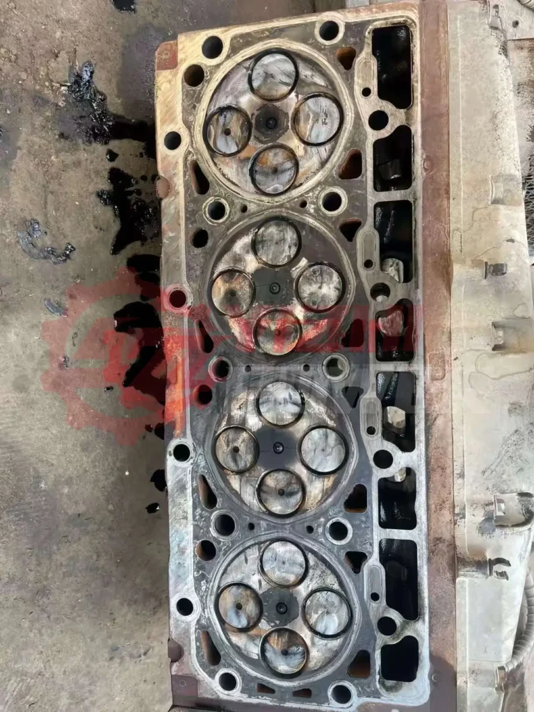 Cummins cylinder head showing failure symptoms such as cracking, warping, and surface damage in diesel engine operation