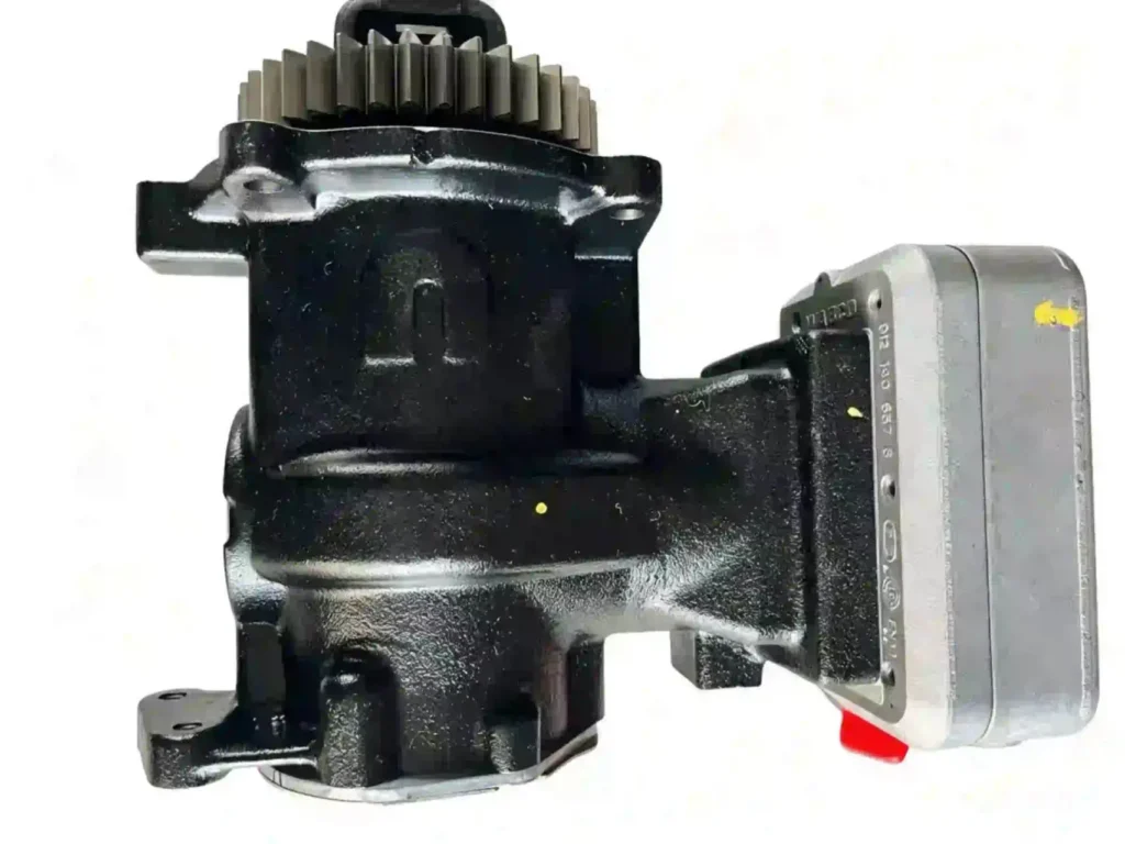 Close-up of the mounting flange and coolant ports on a Cummins X15 air compressor to ensure precise fitment for engine maintenance.