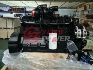 Genuine Cummins 6CT engine assembly in warehouse showing alternator and DCEC CCEC fuel filters