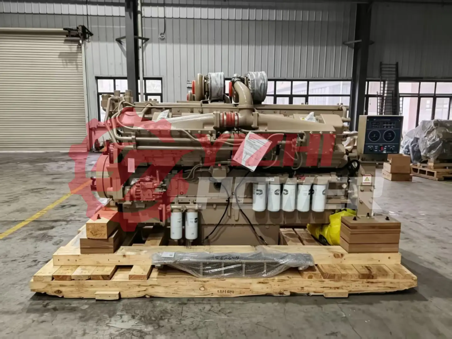 Rear view of Cummins K50 engine assembly showing the official red CCEC logo on the flywheel cover.