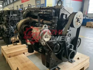 Genuine Cummins M11 diesel engine showing front accessory belt drive and alternator
